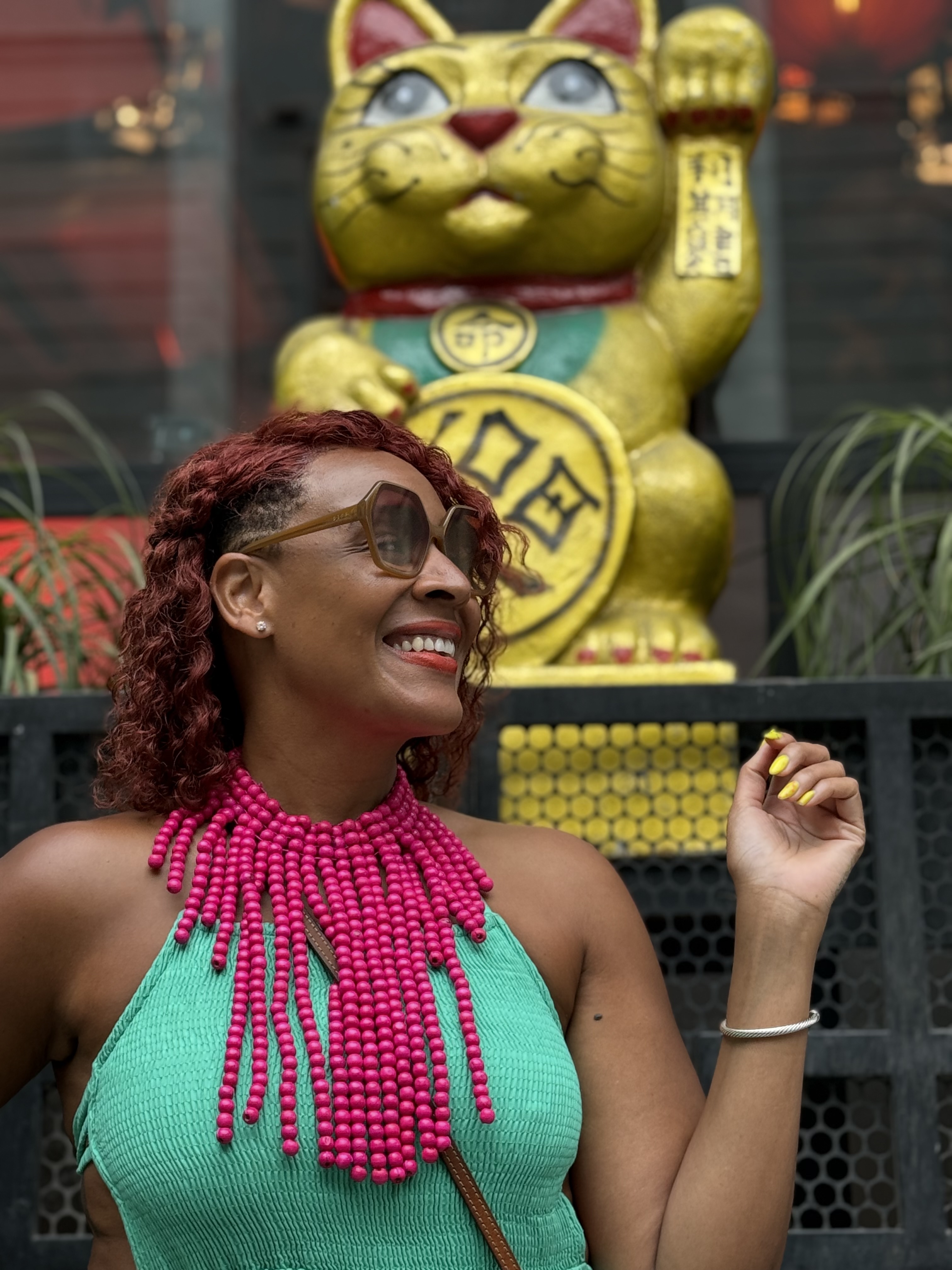 Qiara standing in front of a mountain in brazil with her arms ups in a receiving position